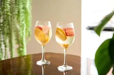 two wine glasses with fruit in them on a table at Hotel Park Suites in Lima