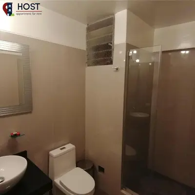 a bathroom with a toilet and a shower and a sink at Host, Apartment for rent in Lima