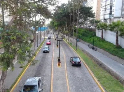 a street with cars driving down a city street at Host, Apartment for rent in Lima