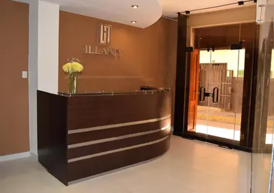 a lobby with a vase of flowers on a counter at Illariy Hotel in Huancavelica