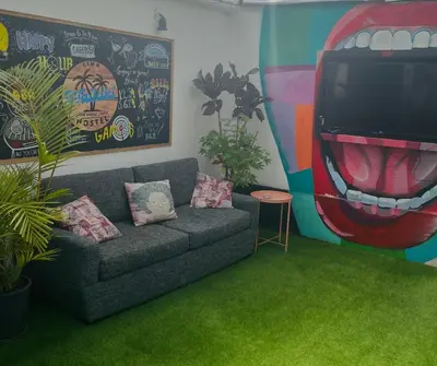 a living room with a couch and a large tv at Waikiki Hostel in Lima