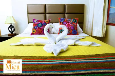 two swans made out of towels on a bed at Hostal Mica in Abancay