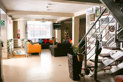 a living room with a couch and a staircase at Hostal Mica in Abancay