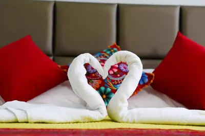 two towels in the shape of a heart on a bed at Hostal Mica in Abancay