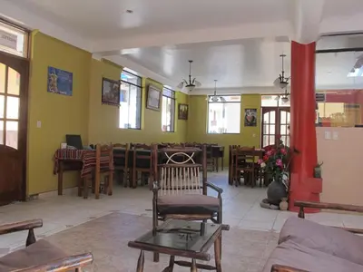a living room with a chair and a dining room at Tumy house B&B in Ollantaytambo