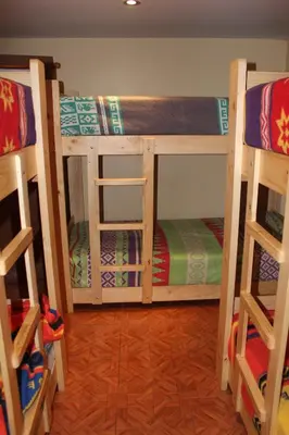 two bunk beds are in a room with at Suspiros del Inka in Lima