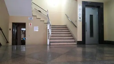 a hallway with a staircase in a building at Miraflores Departamentos in Lima