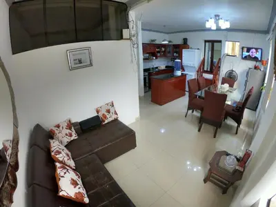 a living room and kitchen with a couch and a table at Miraflores Departamentos in Lima