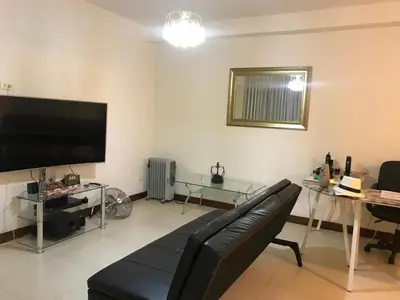 a living room with a couch and a flat screen tv at Edificio California en Centro Historico in Lima