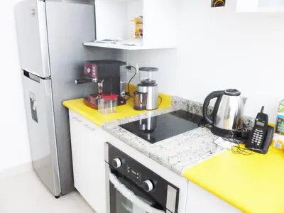a kitchen with a sink and a refrigerator at Edificio California en Centro Historico in Lima