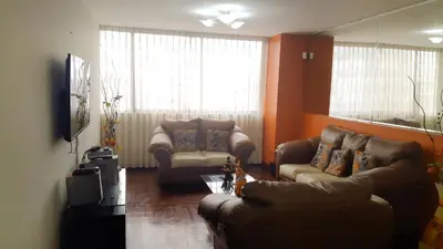 a living room with two couches and a table at Apartment Miraflores Pardo in Lima