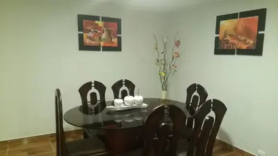 a dining room with a glass table and chairs at Apartment Miraflores Pardo in Lima