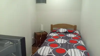 a bedroom with a bed with a comforter on it at Apartment Miraflores Pardo in Lima