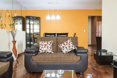 a living room with a couch with pillows on it at Apartment Miraflores Pardo in Lima