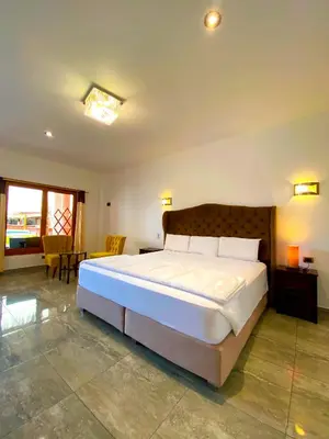 a bedroom with a large bed in a room at Hotel Resort Thiago in Chincha Alta