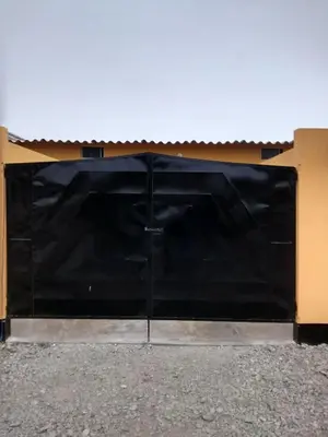 a large black garage door on a house at Motel Sahara Suites in Barranca
