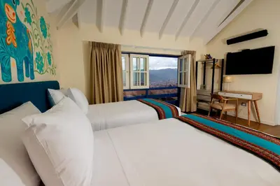 a hotel room with two beds and a window at 7 Toritos Hotel Boutique by Hacienda in Cusco