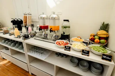 a kitchen with a buffet of fruits and vegetables at 7 Toritos Hotel Boutique by Hacienda in Cusco