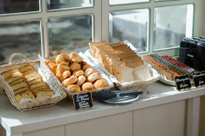 a buffet of bread and pastries on a counter at 7 Toritos Hotel Boutique by Hacienda in Cusco