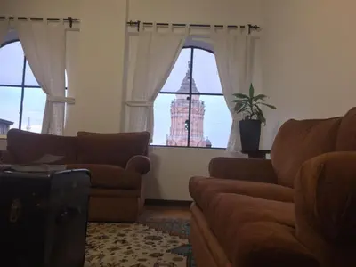 a living room with a couch and a large building at Best place in Plaza Mayor Lima, Pizarro building in Lima
