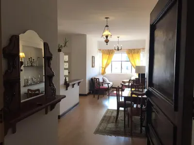 a living room with a table and chairs and a dining room at Best place in Plaza Mayor Lima, Pizarro building in Lima