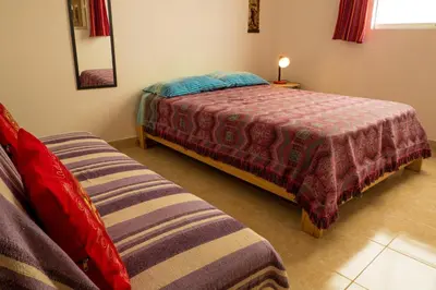 a bedroom with a bed and a couch at Cruz del Sur in Pucusana