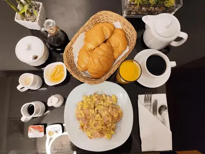 a table with a plate of food and a bowl of bread at Starlight Inn in Pisco