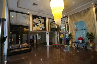 a lobby with a couch and a chandelier in a building at Hilton Garden Inn Lima Surco in Lima