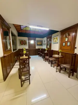 a dining room with tables and chairs and a unintention at Hotel La Molina in Lima