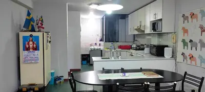 a kitchen with a table and a table and chairs at Apartamento Marco Airport in Lima