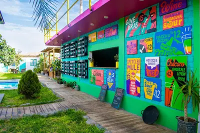 a building with colorful signs on the side of it at The Upcycled Hostel in Ica