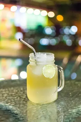 a mason jar of lemonade with a lemon slice in it at The Upcycled Hostel in Ica