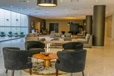 a lobby with couches and tables and chairs at Jose Antonio Deluxe in Lima