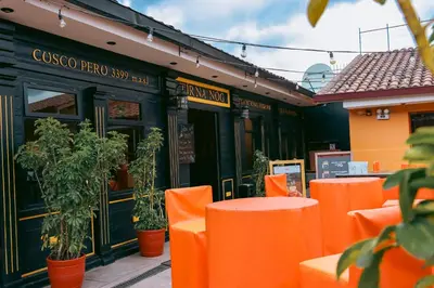 an orange table and chairs in front of a restaurant at Wild Rover Cusco in Cusco