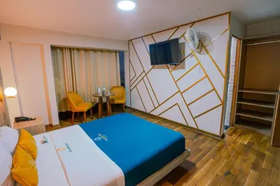 a hotel room with a bed and a tv at Golden Mar Hotel in Lima