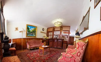 a living room with a couch and a table at Hotel Museo Casona Ugarte Leon in Concepción
