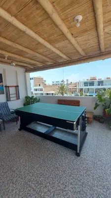 a ping pong table in a room with a roof at El Capricho Paracas in Paracas
