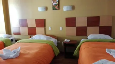 a hotel room with two beds in a room at Tierra del Inka in Cusco