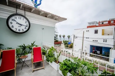 a clock on the side of a building with plants at Villa Barranco by Ananay Hotels in Lima