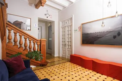 a living room with a large tv on the wall at Villa Barranco by Ananay Hotels in Lima