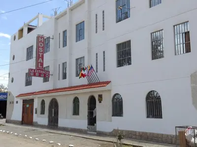 a large white building with a sign on it at Hostal La Estancia in Ica