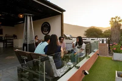 a group of people sitting on a balcony at Desert Nights Hostel in Ica