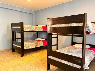 two sets of bunk beds in a room at Desert Nights Hostel in Ica