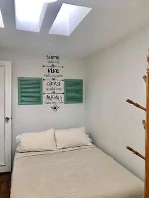 a bedroom with a bed with green and white walls at Lindos Apartamentos en San Isidro in Lima