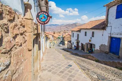 a street with a sign on the side of a building at Tucan Hostel in Cusco