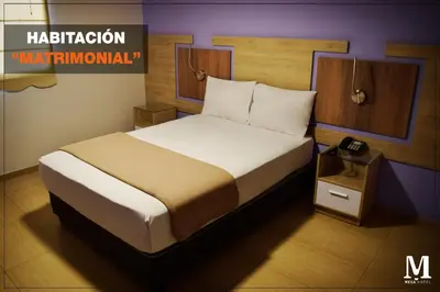 a bedroom with a bed in a room at Hotel Mega in Lima