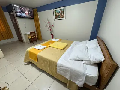 a bedroom with a large bed in a room at Illari Wari l - Hotel Sauna in Ayacucho