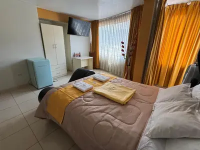 a bedroom with a large bed with two towels on it at Illari Wari l - Hotel Sauna in Ayacucho
