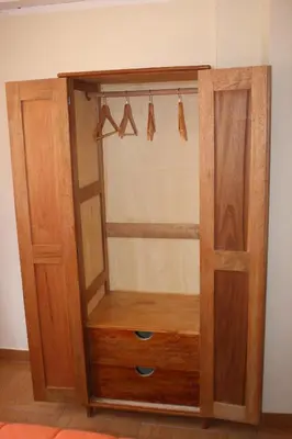 a wooden cabinet with hangers in a room at Big Vacation Hostel in Cusco