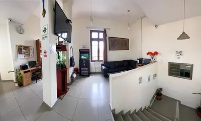 a living room with a couch and a stairway at Lima House Hostel in Lima